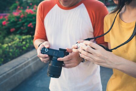 Tourist couple looking at their camera screen.の写真素材