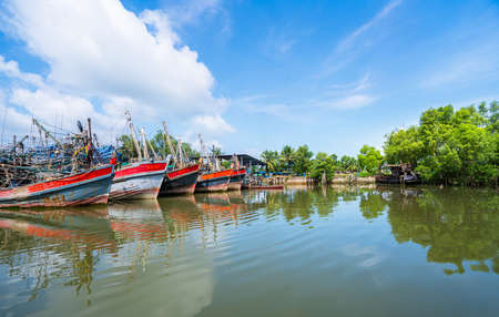 Fishing Boats in a Harbour and Blue Sky in Thailand.の写真素材