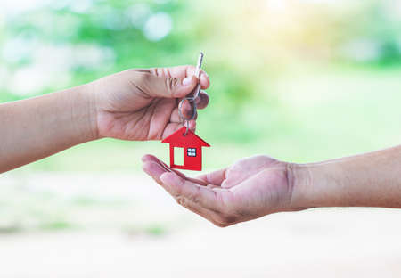 Real estate agent giving keys to apartment owner.の写真素材