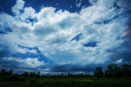 night sky with cloud and stars over the fieldの写真素材