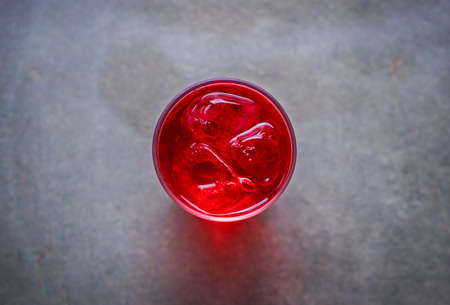 glass of sparkling water with ice cubes on table.の写真素材