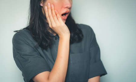Woman has toothache,Tooth Pain And Dentistry.の写真素材