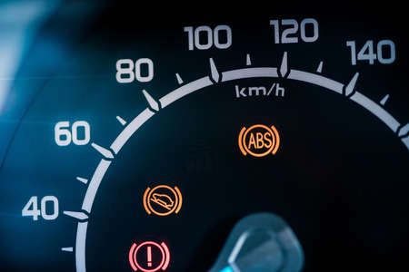 Many different car dashboard lights with warning lamps illuminated.の写真素材