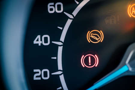 Many different car dashboard lights with warning lamps illuminated.の写真素材