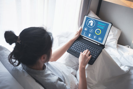 Woman use tablet with program smart home technology interface on the screen.の写真素材