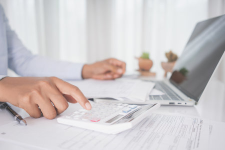 Accountant working with tax forms.Tax deduction planning concept.の写真素材