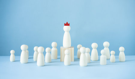 Successful leader concept.Wood doll model on blue background.の写真素材