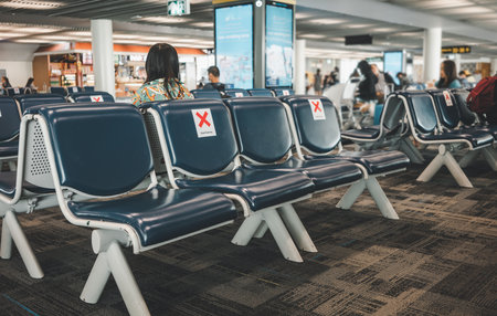Social distancing in airport.Rows empty chairs indicating where you can sit.の写真素材