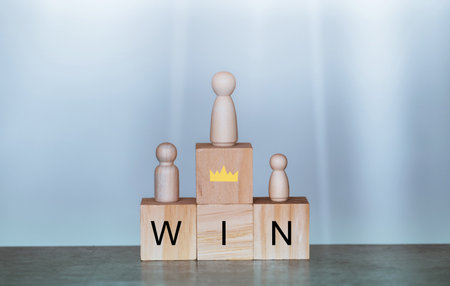 Champion and win concept.Wood block with and word win,wooden doll, Business and success concept.の写真素材