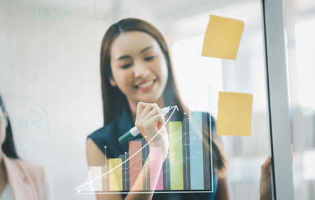 Business woman planning working on marketing plan together, Plan graph growth and increase of chart.の写真素材