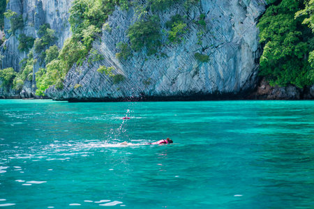 Woman tourists snorkel in pileh bay in Krabi, Thailand.
Travelling tour in asia.Wonderful turquoise sea at andaman sea.の写真素材