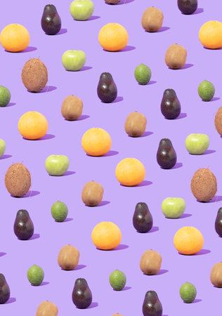Trendy sunlight pattern made of colorfull fresh fruit against pastel violet background. Flat lay.の写真素材