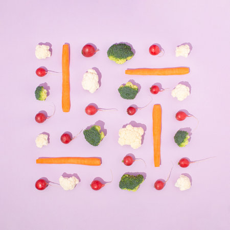 Neatly arranged fresh vegetables on pastel violet background. Minimal flat lay.の写真素材
