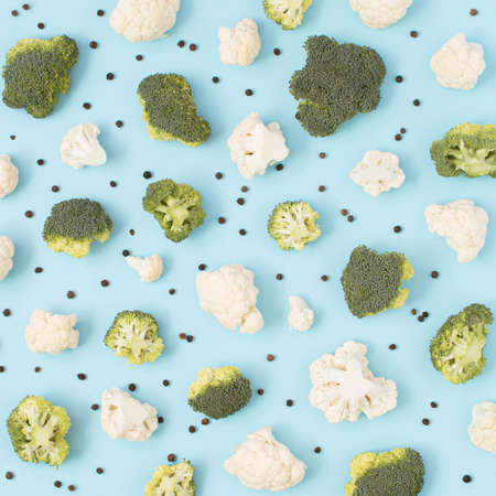 Trendy arrangement made of fresh vegetables and pepper on a pastel blue background.の写真素材