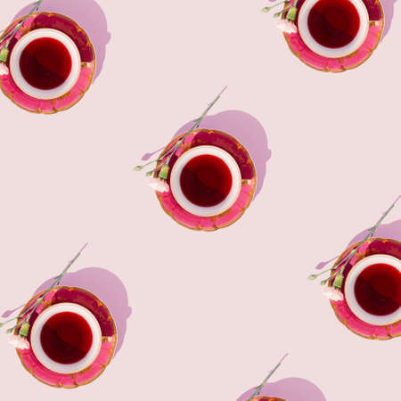 Creative tea cup pattern on pastel pink background. Minimal flat lay.の写真素材