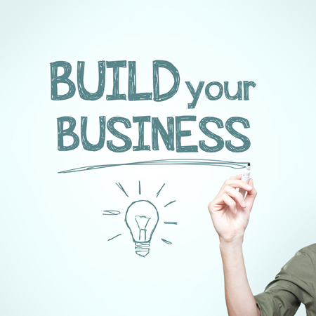 Man writing "build your business", motivational imageの写真素材