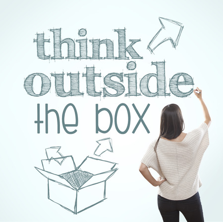 Young woman writing  think outside the box , motivational imageの写真素材