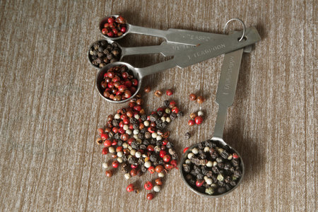 A mixture of peppers. Black, white, red polka dots.