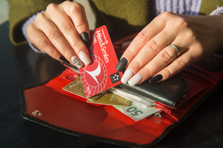 Agadir, Morocco, 10 December 2020: women's hands with a beautiful manicure on a leather wallet with...