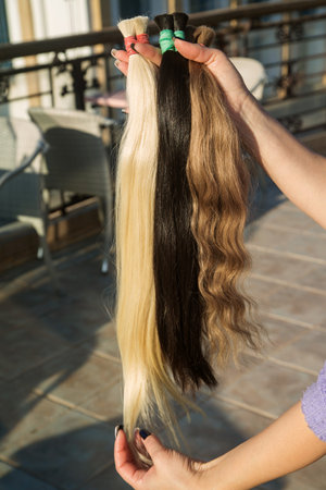 strands of natural womens hair for encapsulation and extension in a beauty salon.の写真素材