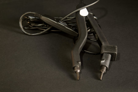 hair extension tongs on a black background. . High quality photo