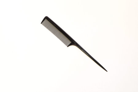 black flat plastic comb on white background