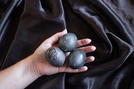 photo of easter eggs in hand on a black background