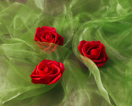 Tree red roses on wave green tulle fabric.. artificial flowers. flat lay minimal modern concept. Gift card creative ideaの写真素材