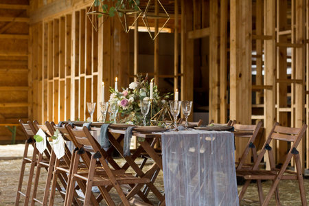 Wedding party in a wooden barn. Candles and bouquet. Vintage Style.