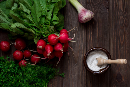 Bunch of radish, garlic, Herbs and salt on wooden table. Top view. Vintage.の写真素材