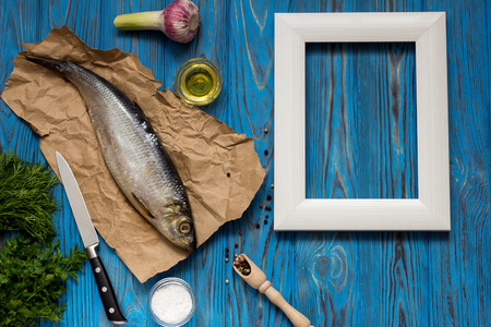 Ingredients for cooking fish: salt, oil, spices, garlic, lemon and herbs. Near the frame for writing a recipe.の写真素材