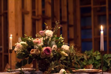 Wedding table is decorated with flowers and candles. Evening banquet.の写真素材
