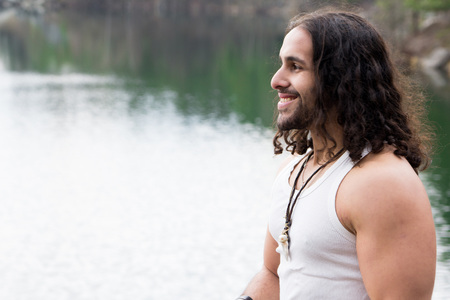 Young Man standing alone outdoor Travel Lifestyle concept with lakeの写真素材