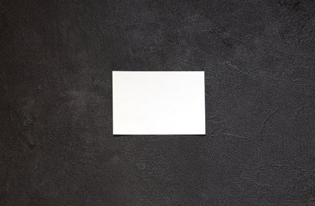 Blank notepad on concrete table. Blank Paper on black concrete background.Copy space