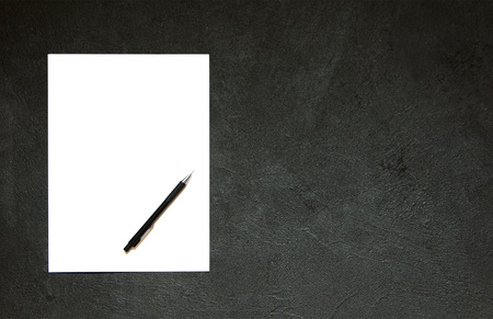 Blank notepad and pencil on concrete table. Blank Paper on black concrete background.Copy spaceの写真素材