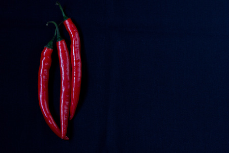 Red chilli pepper on dark blue tablecloth. Top view.の写真素材