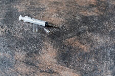 drug abuse concept with closeup on heroin syringe or other narcoticsの写真素材