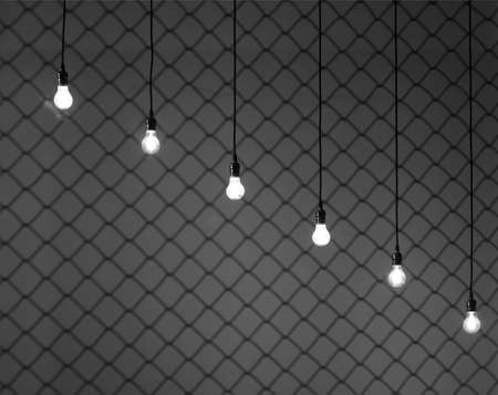 Edison lamps shine through the metal grill. Vintage decoration.の写真素材