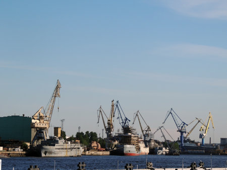 cargo ships on the Neva River against the background of port cranes on a summer dayの写真素材