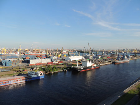 View of the seaport on a sunny summer day, a lot of colorful cargo containers, the city in the...