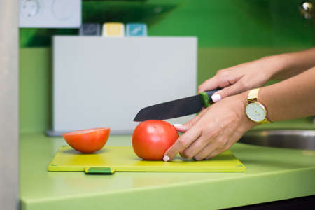 Cut with vegetables cucumbers tomatoes on a boardの写真素材