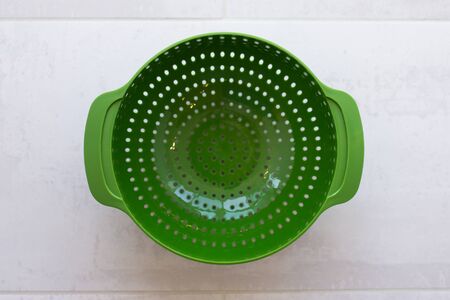 Plastic cups of a multi-colored dish in the kitchenの写真素材