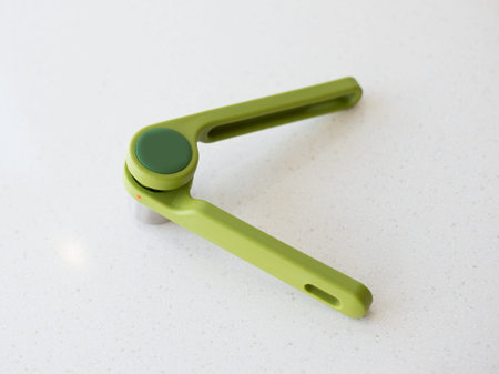 Spoon large green with holes convenient beautiful plastic for kitchen on green background, cook,...