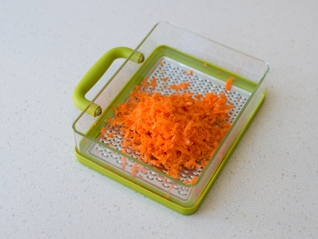 Green plastic grater. isolated on white background carrotの写真素材