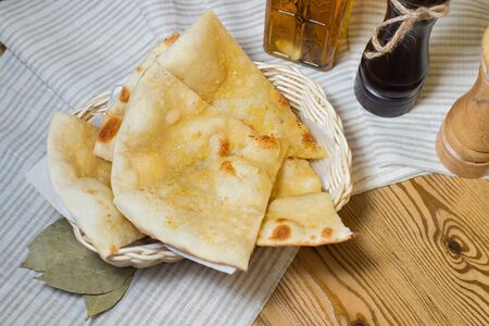 Flat bread with cheese on wood napkinの写真素材