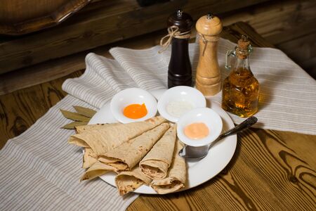 Bread round thin white with sauce on a white plate on the treeの写真素材