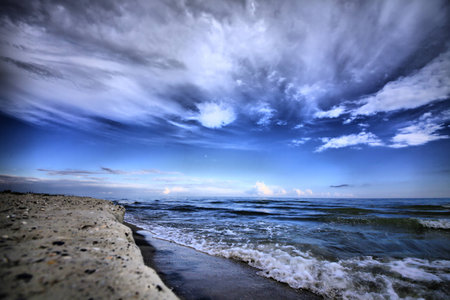 The sea shore and the sky with cloudsの写真素材