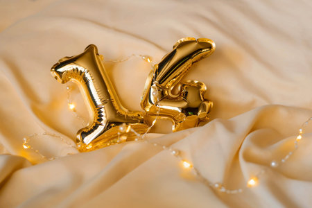 Gold foil number balloons 14 Valentine's Day on a festive white background.