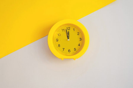 Yellow clock on a background in trendy colors. The color of 2021. Yellow, gray isolate.の写真素材