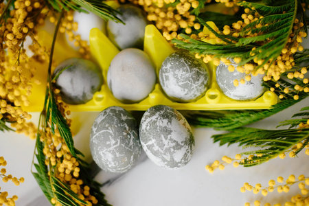 Happy Easter. Marble Eggs Mimosa on the Kitchen Table. Design and traditional decoration for the...